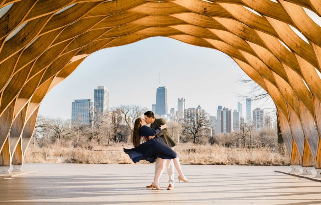 Couple dipping under Honeycomb sculpture in Lincoln Park